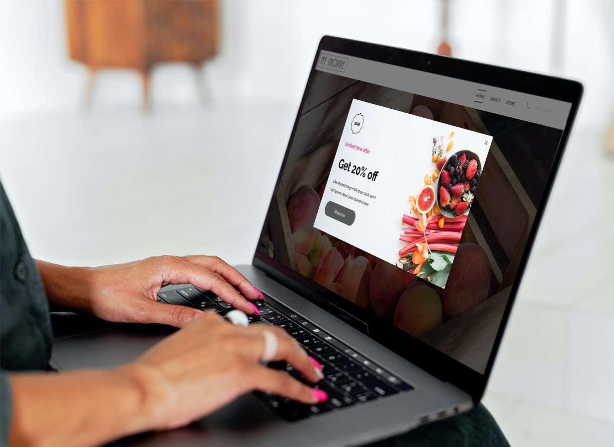 Person using laptop with popup advertisement featuring food.