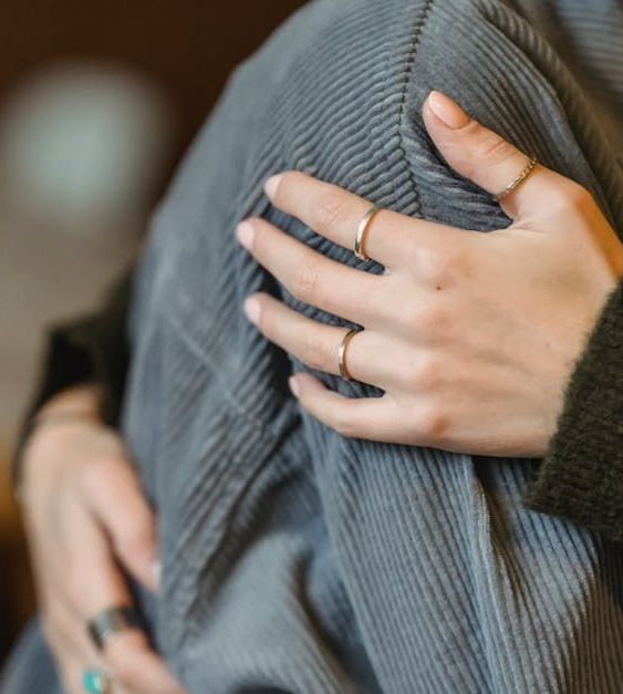 A close up of a person 's hands with rings on them