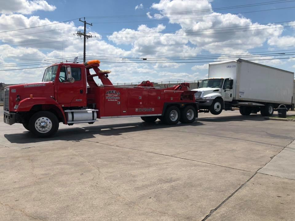 Red Truck Towing White Truck - San Antonio, TX - Abel’s Towing