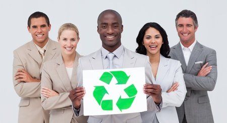 people holding a recycling sign