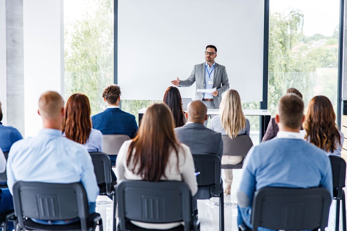 Man Giving a Speech on a Seminar — Richmond, VA — Winn With Mark