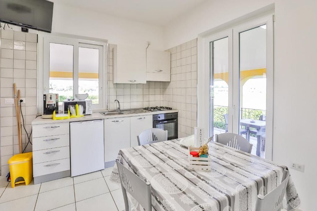 Una cucina con tavolo, sedie e televisione