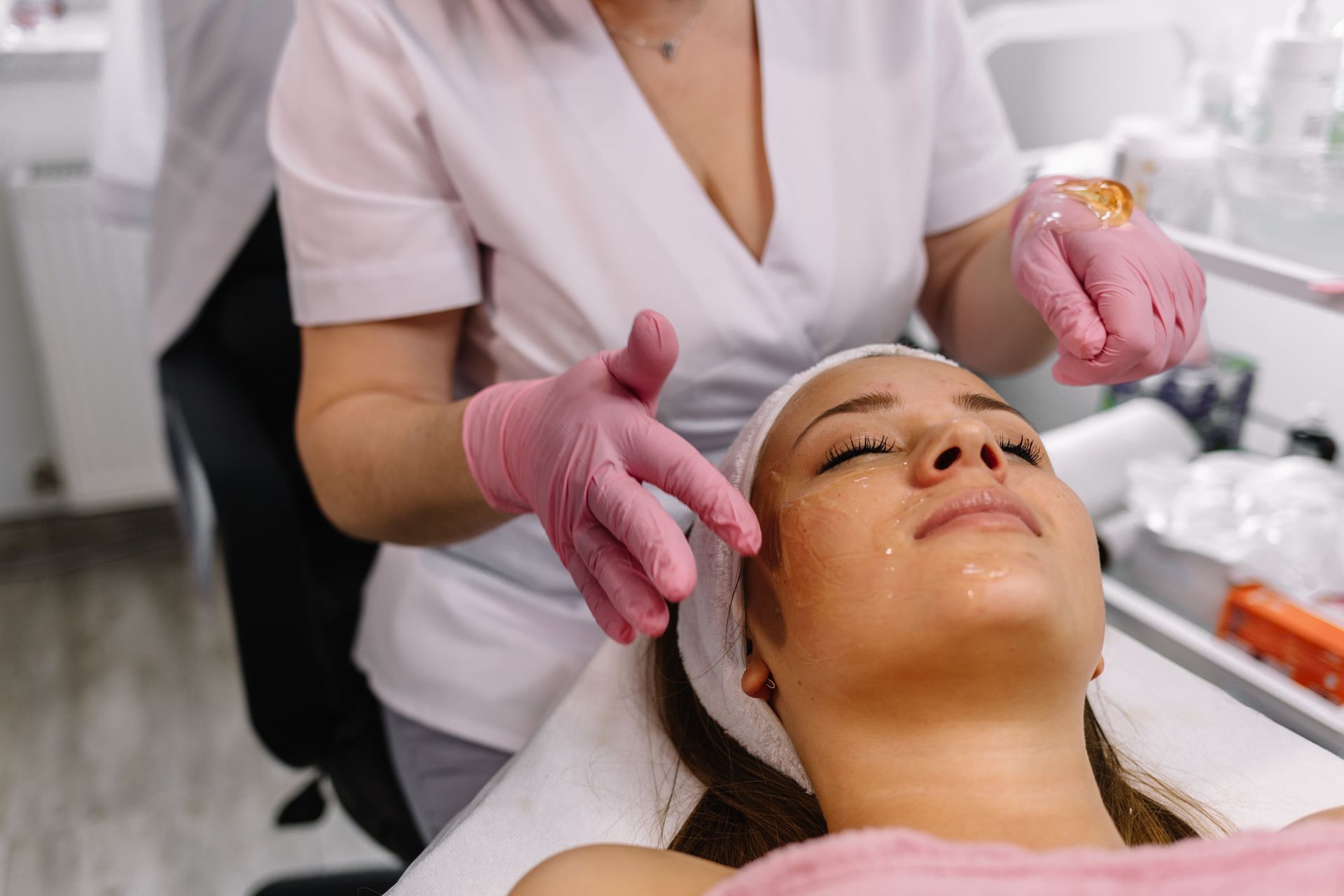 A woman is getting a facial treatment at a beauty salon