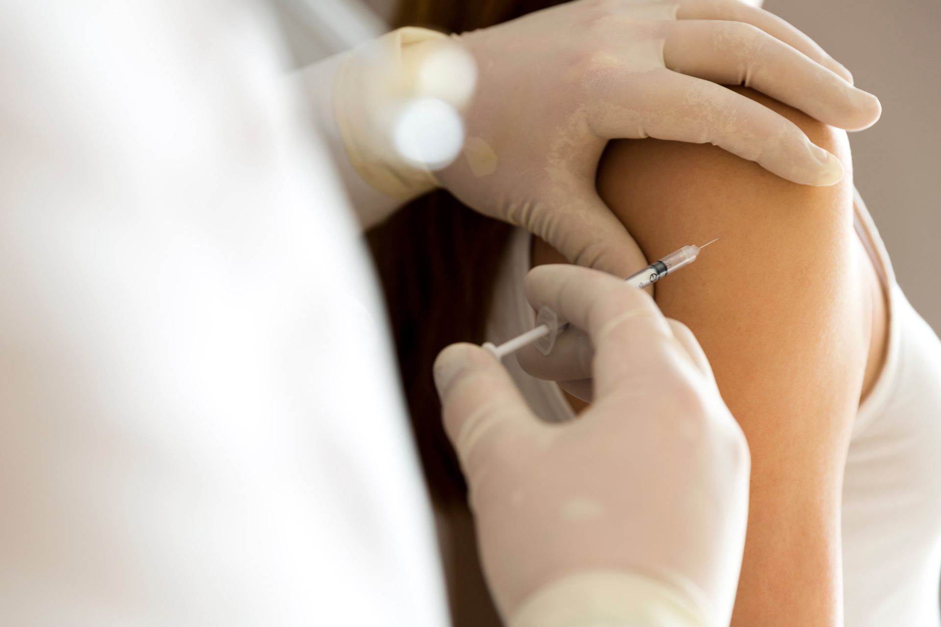 A woman is getting an injection in her arm