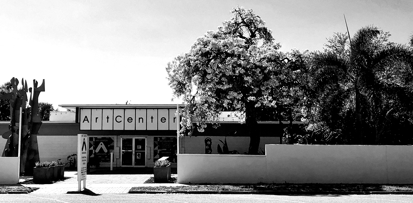 Black and white photo of the ArtsConroe building with a large tree in front.