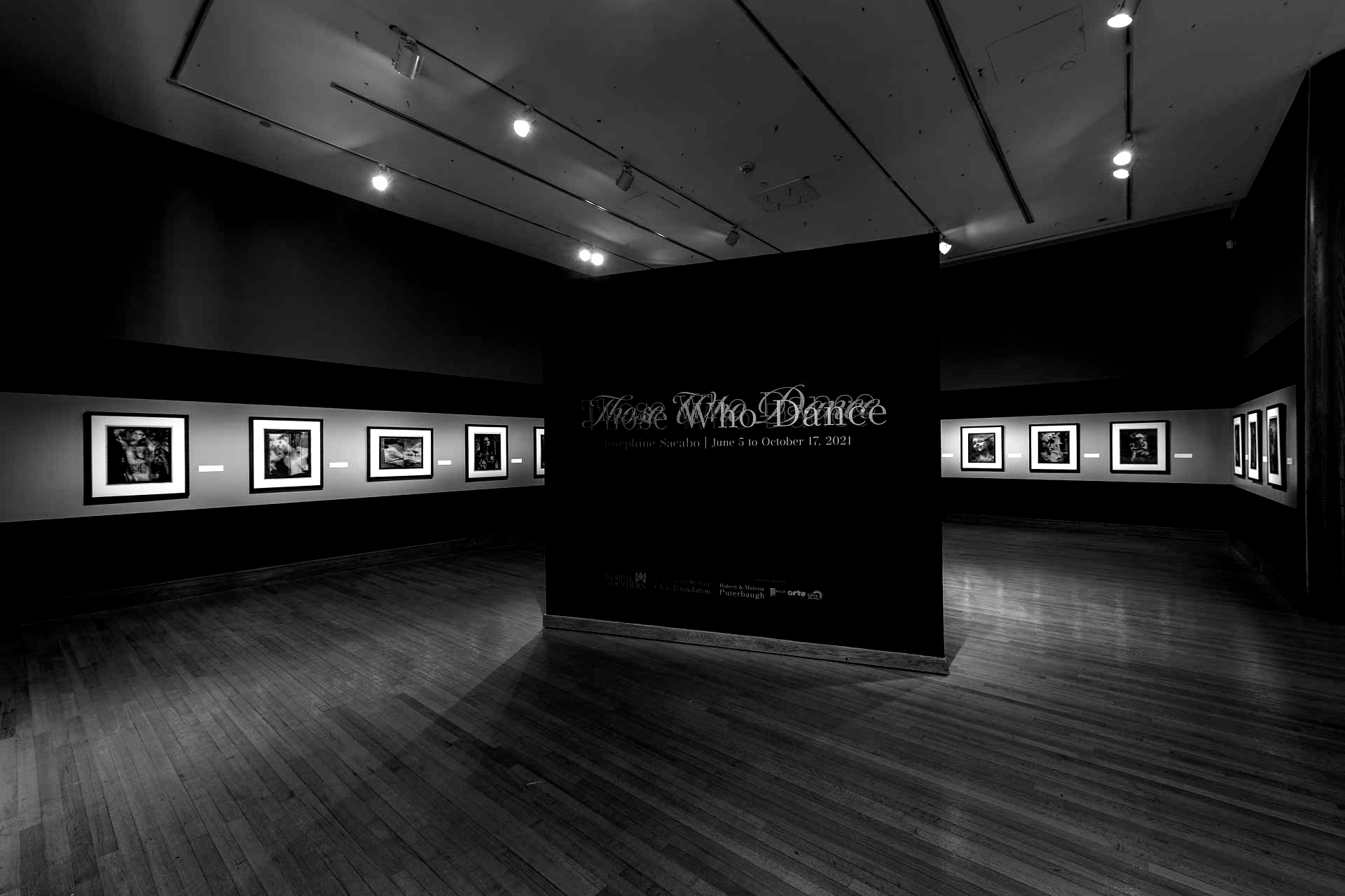 Black and white art gallery. Black backdrop with white text: 