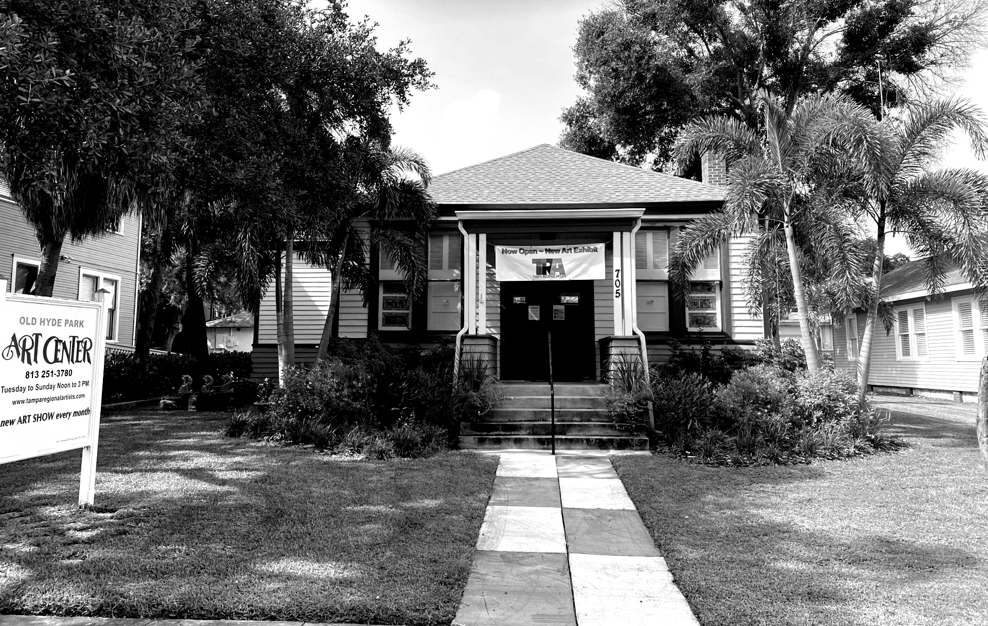 Black and white photo of the Dunedin Fine Art Center.  A building with a sign that says 