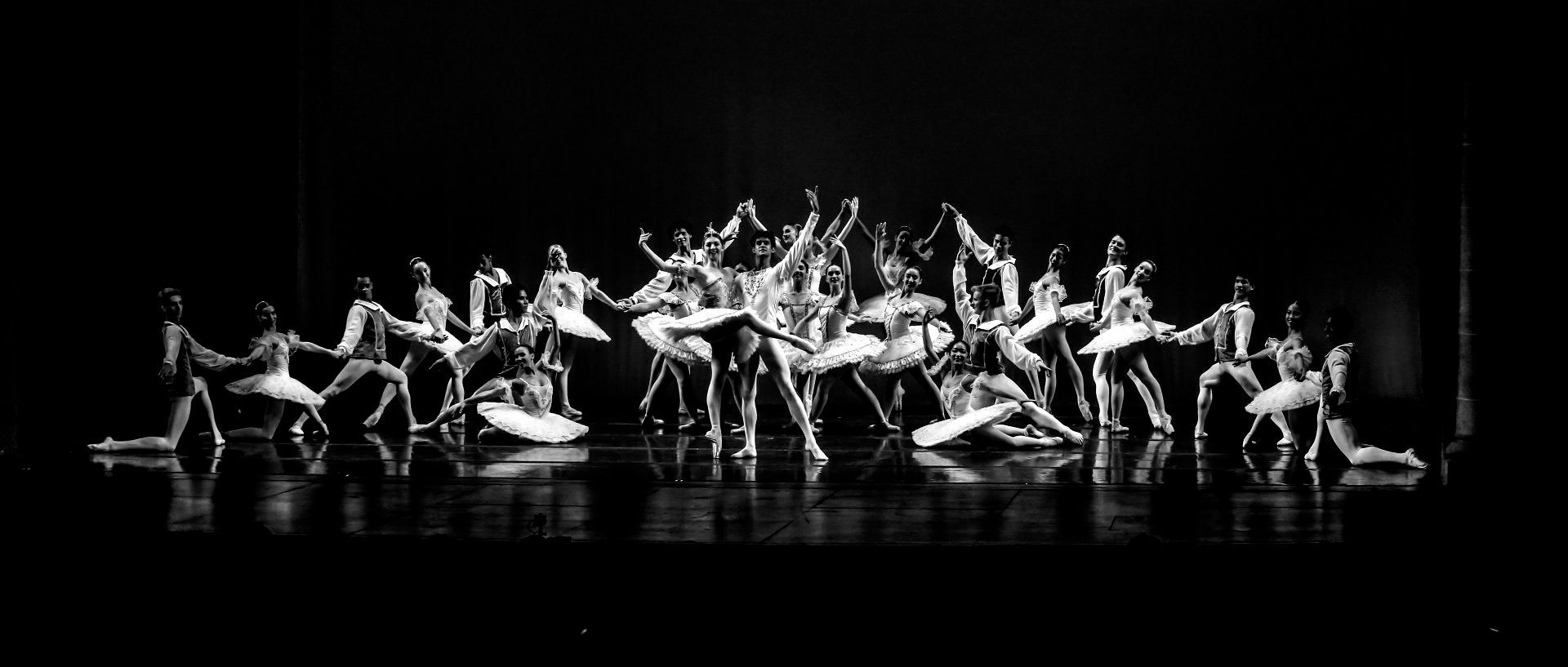 Ballet dancers performing on stage. Black and white photo.