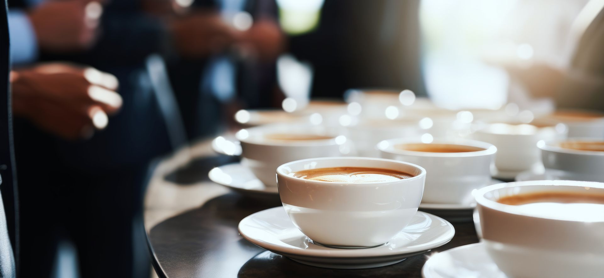 A tray of coffee cups and saucers on a table.