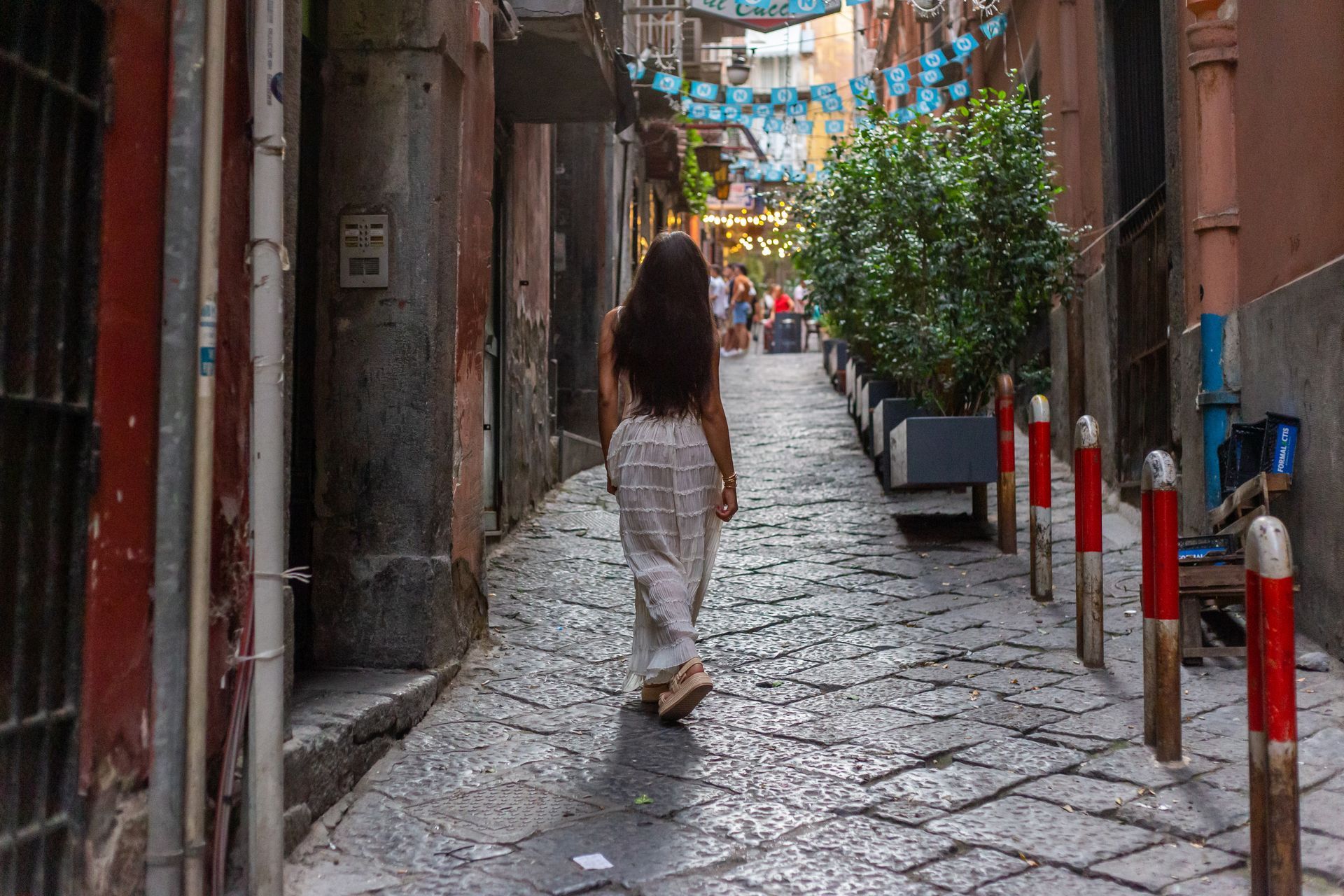 Woman walking in a picturesque alley in Naples – Travel Photography.