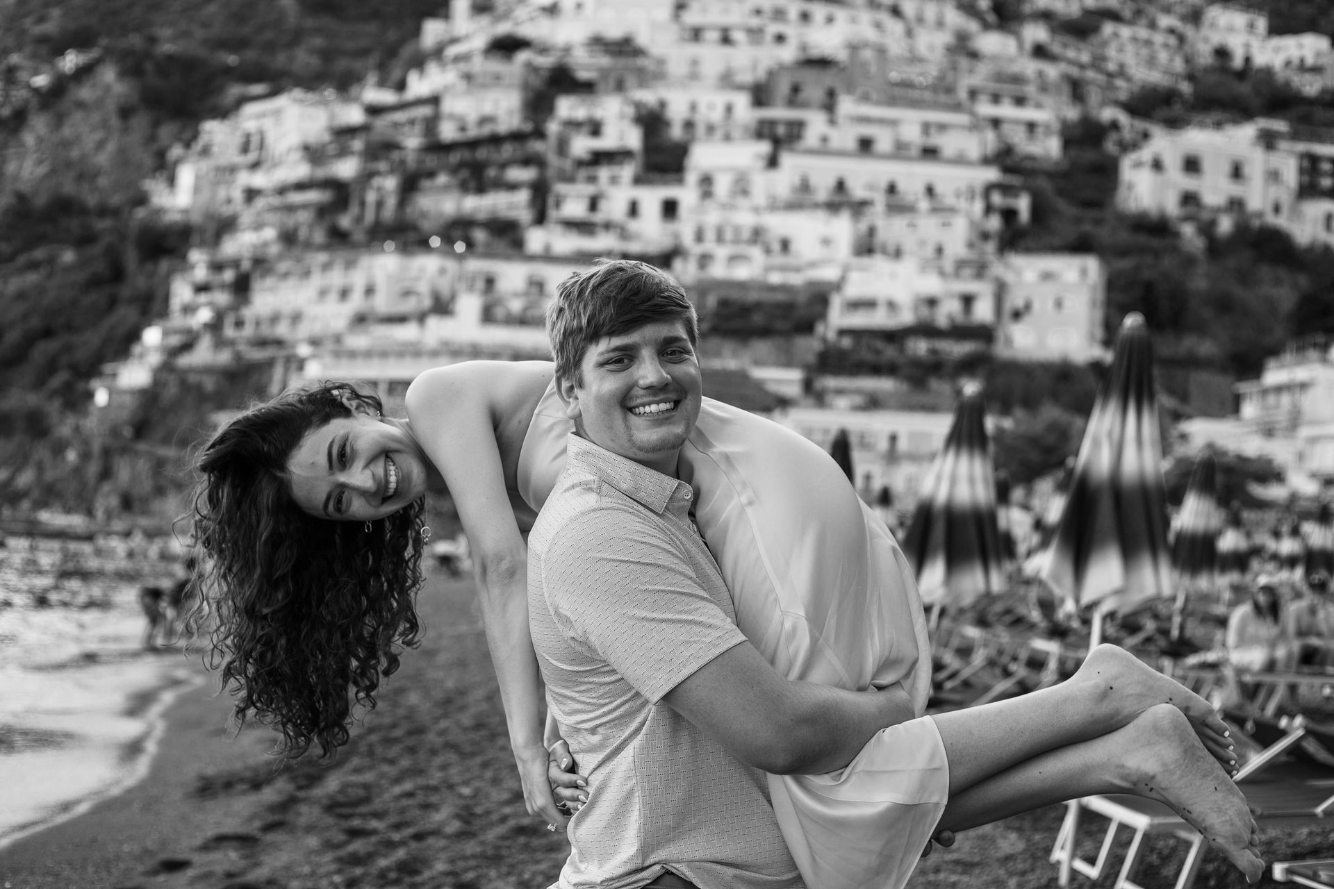 Couple embracing with a view of Positano – Intimate Photography Session.