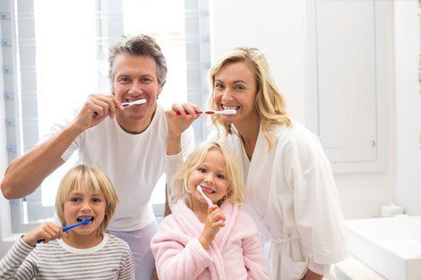 Teeth Whitening — Family Brushing Teeth Together in Warren, OH