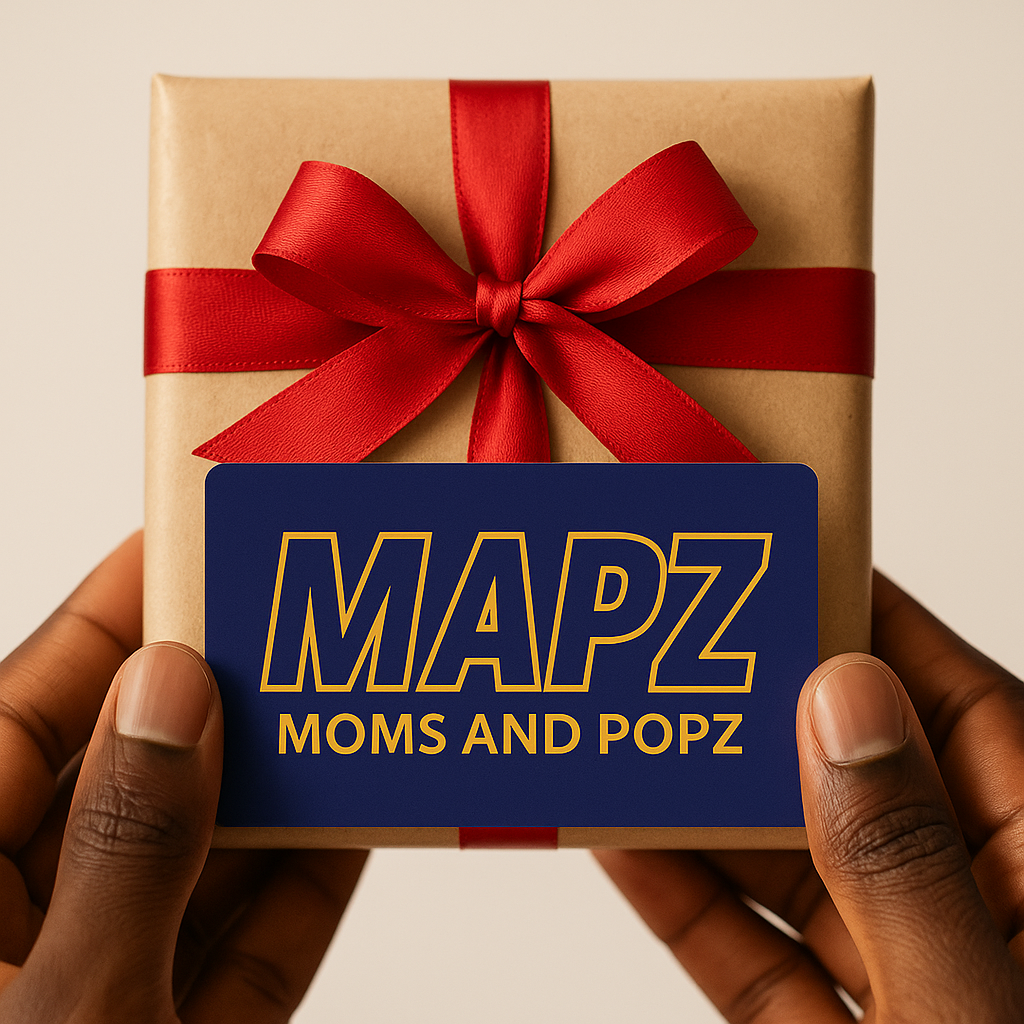A person is holding a gift box with a mapz mom and popz tag on it