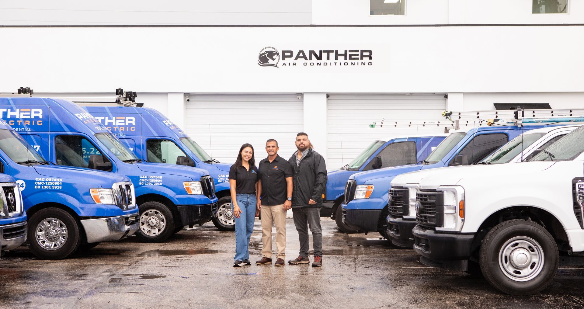 A mitsubishi air conditioner is sitting on the side of a building.