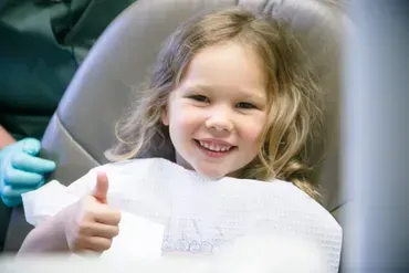 Child with thumbs up