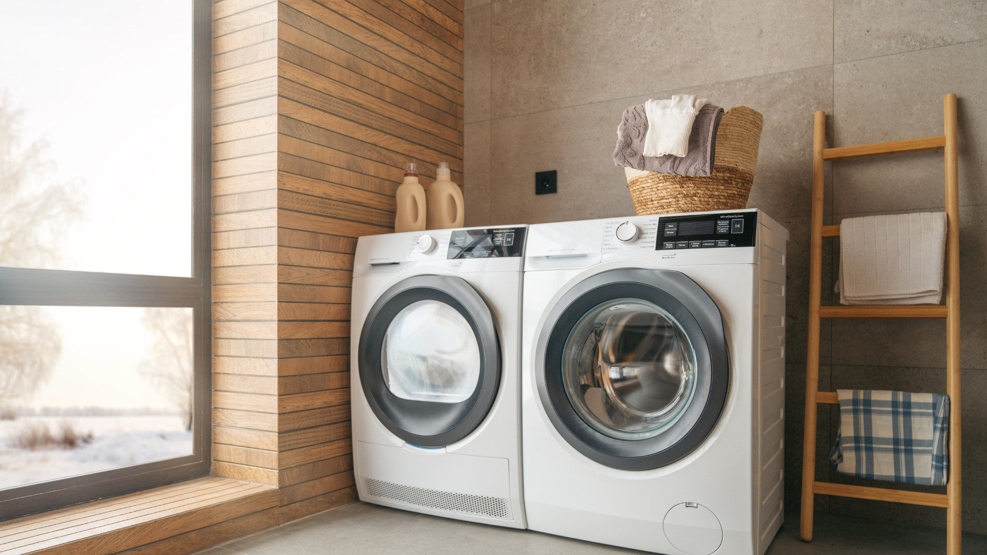 A washer and dryer are sitting next to each other in a laundry room.