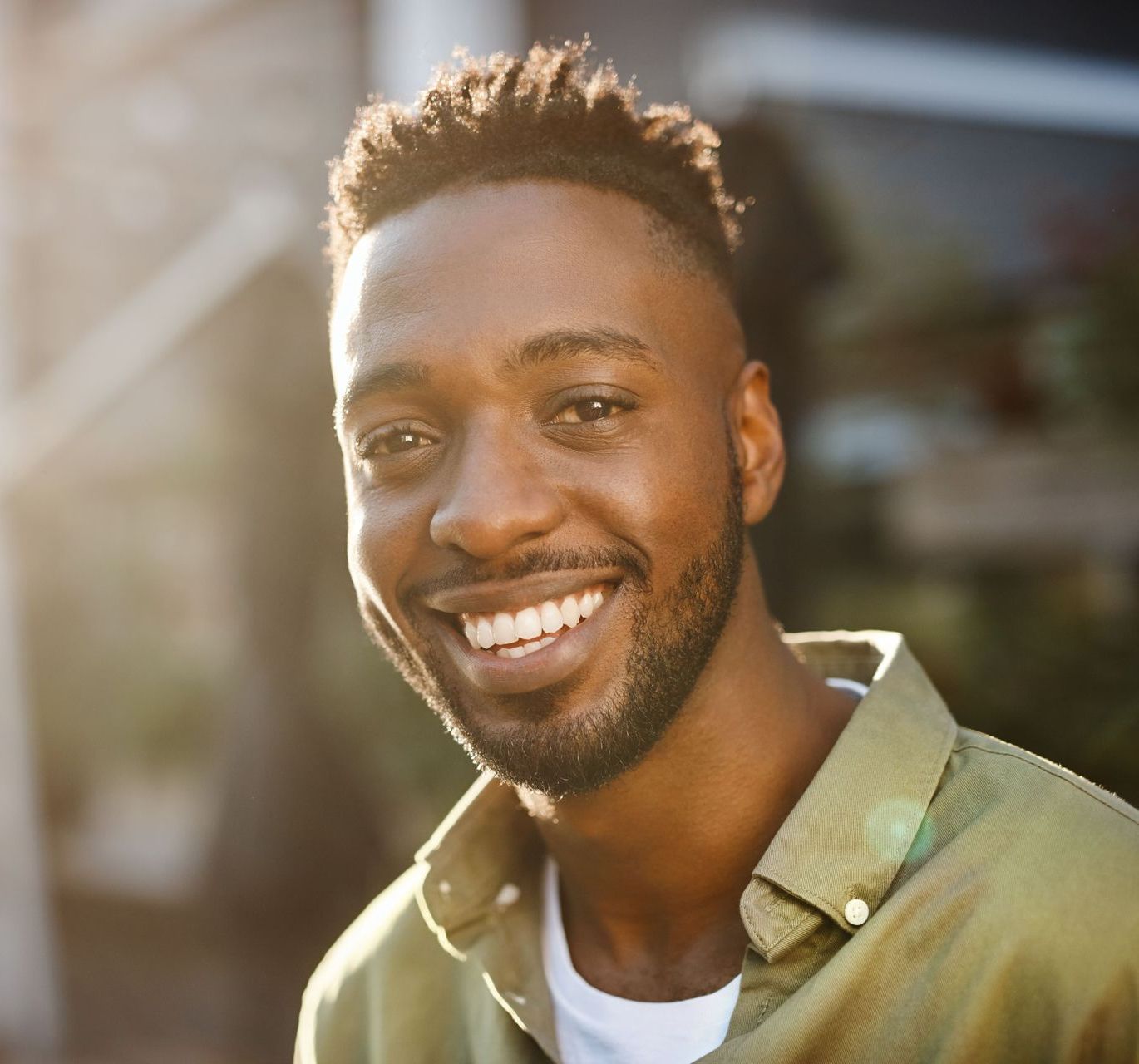 A man with a beard is smiling for the camera.