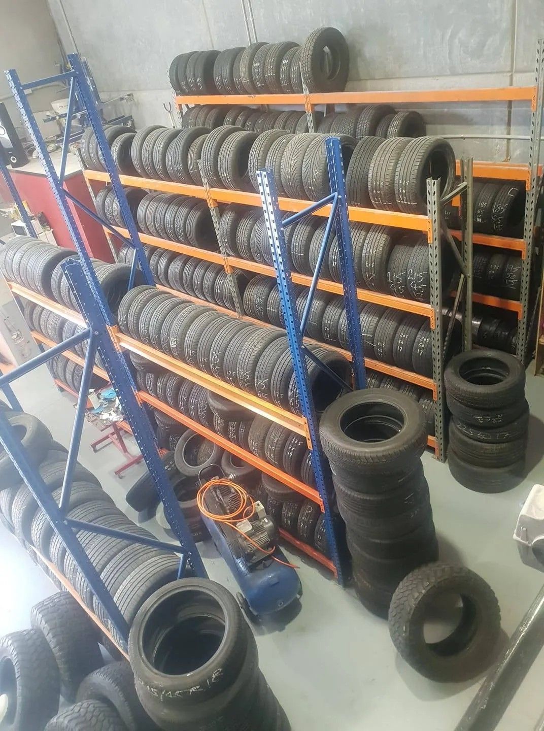 A Lot of Tyres On Shelves In A Mechanical Shop — Budget Tyre Shed In Charmhaven, NSW