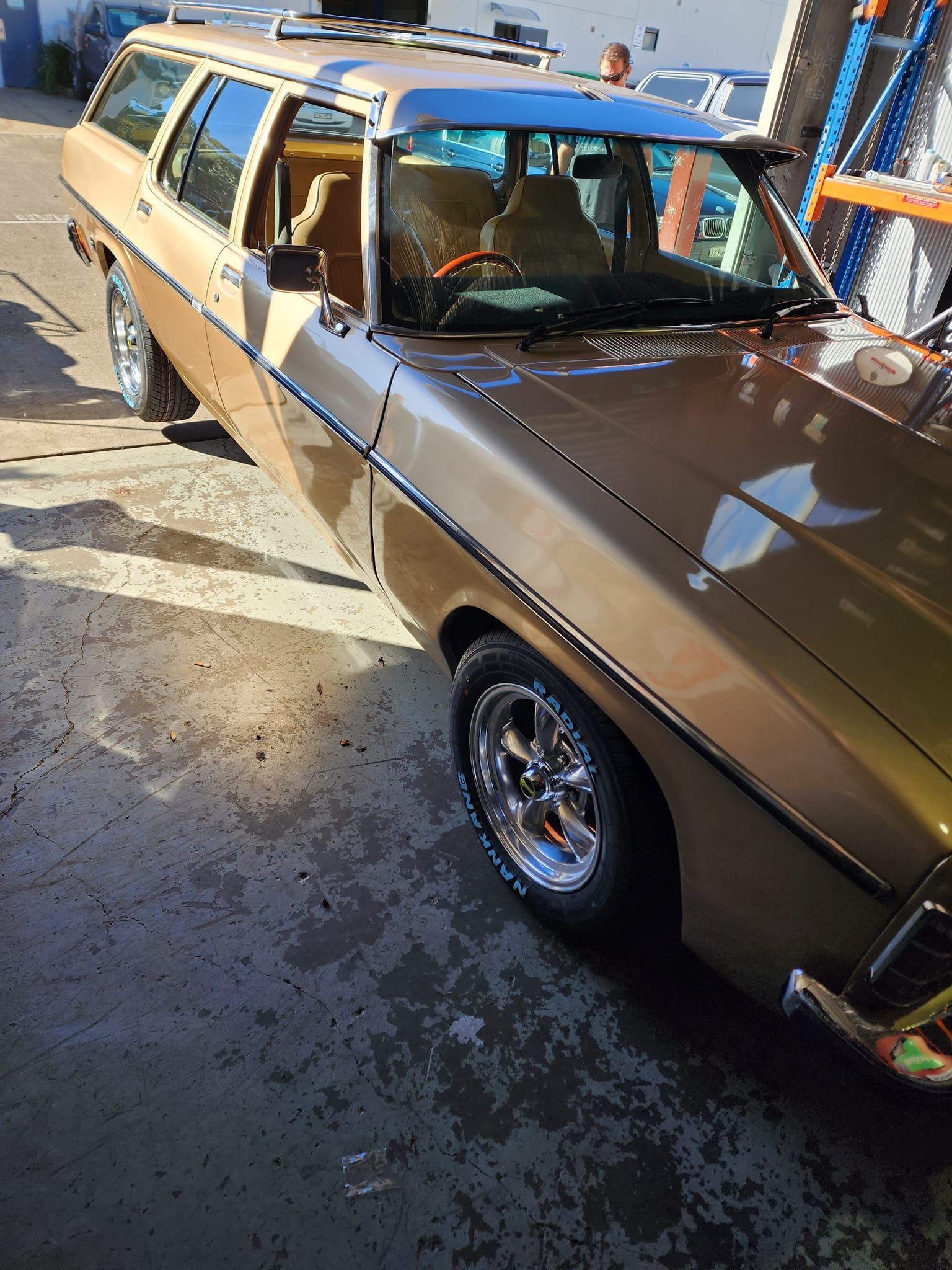 A Tan Car Parked in A Garage With Shiny Wheels — Budget Tyre Shed In Charmhaven, NSW