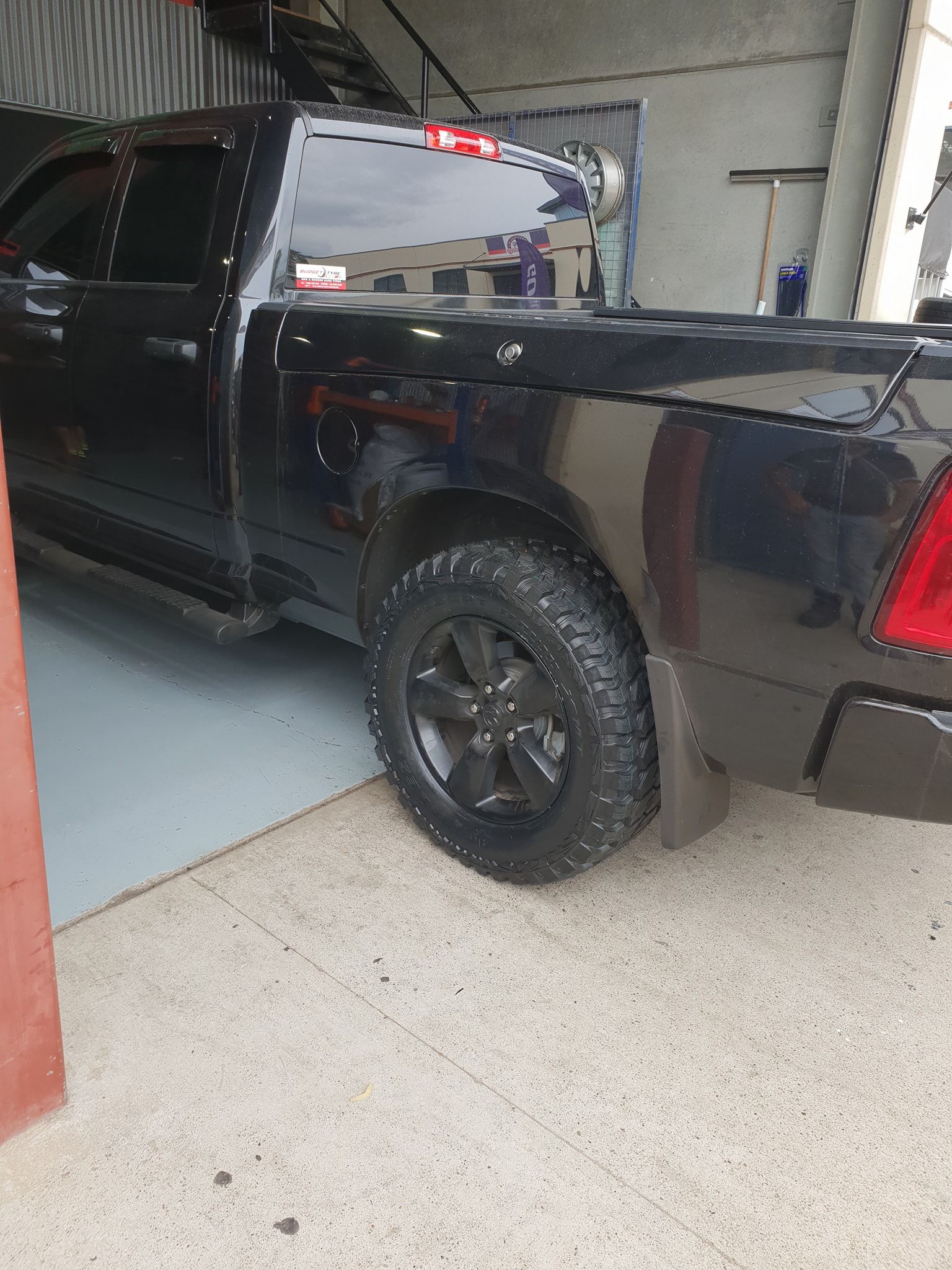 A Close Up Of A Full Black Truck Parked In A Garage — Budget Tyre Shed In Charmhaven, NSW