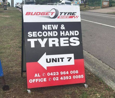 A Sign that Says Budget Tyre Shed New and Second Hand Tyres — Budget Tyre Shed In Charmhaven, NSW