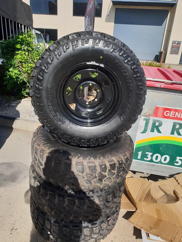 A Few Tyres Stacked Outside With Dirt On them — Budget Tyre Shed In Charmhaven, NSW