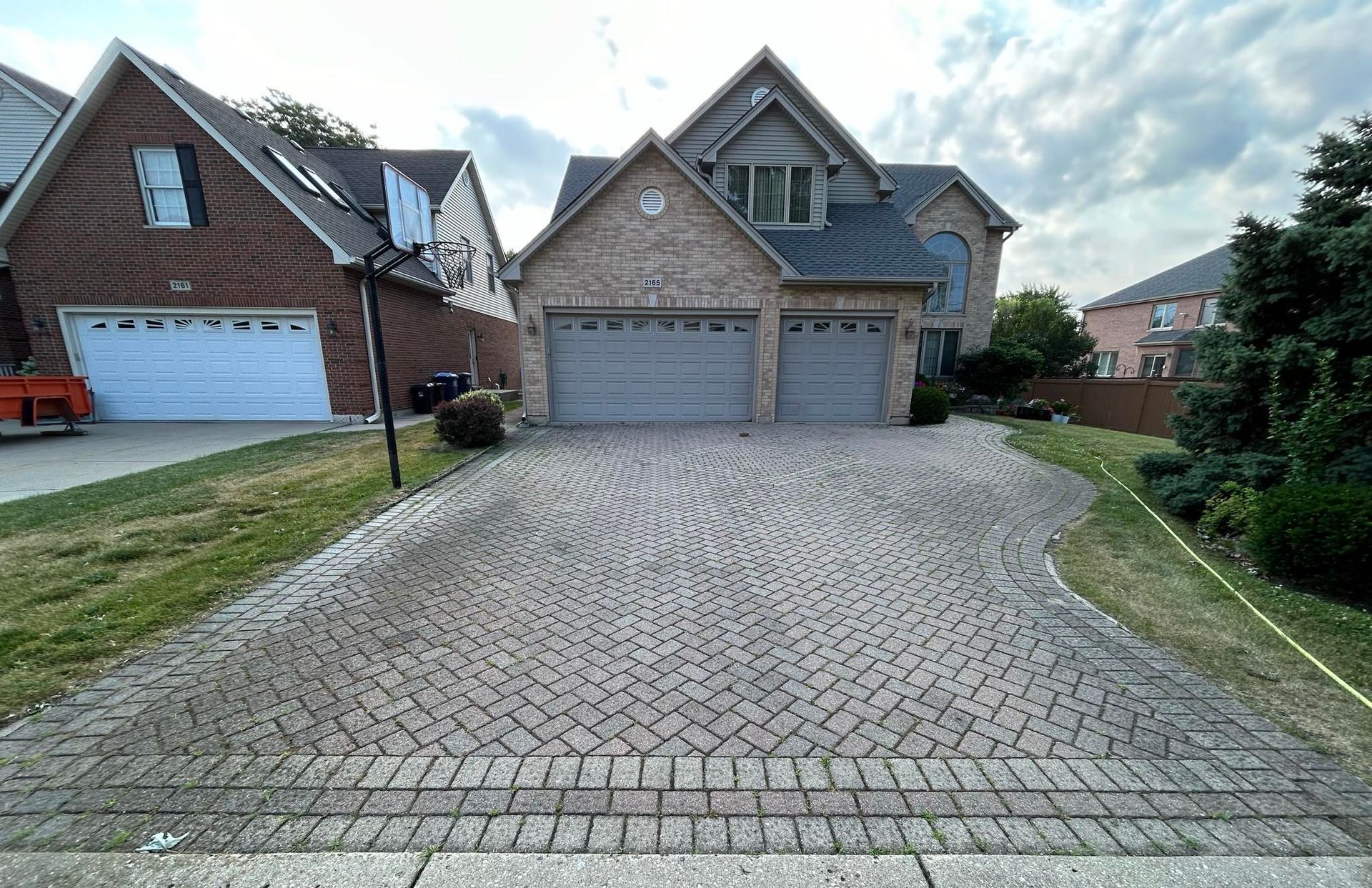 Image of a paver stone driveway that needs to be washed and sealed.