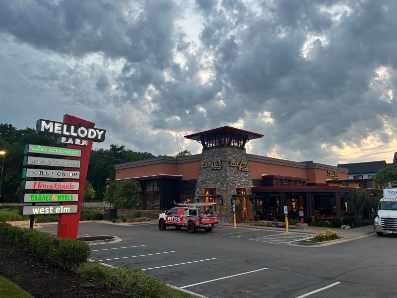 Image of Peters Power Wash services doing a pressure washing job for a local business.