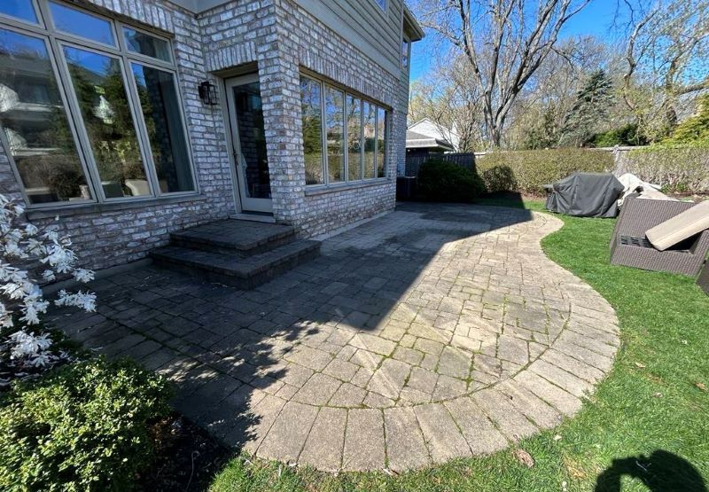 Image of pavers in a patio that have not been cleaned.