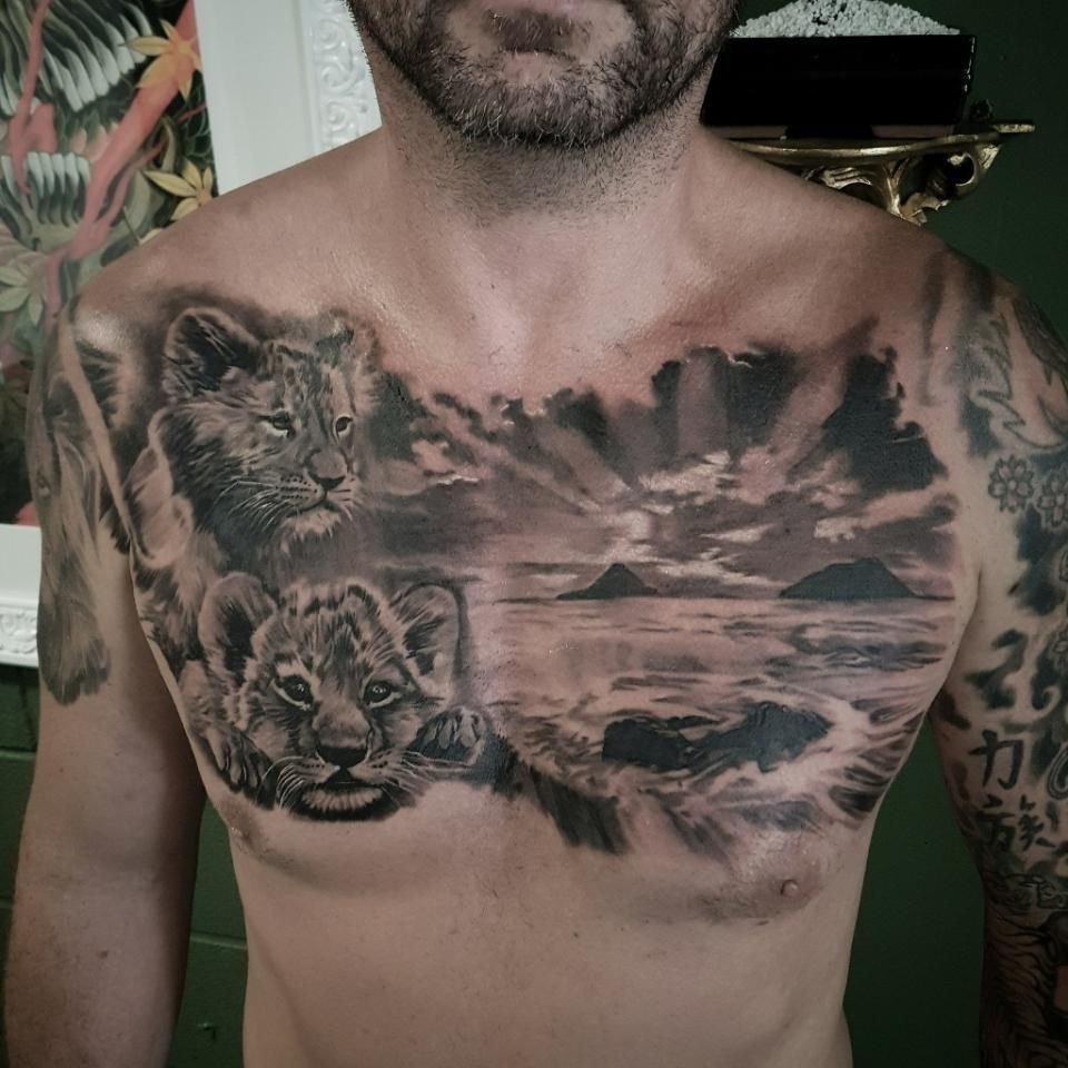 A Man Has a Tattoo of Two Lions on His Chest — Gallery Tattoo in Maitland, NSW