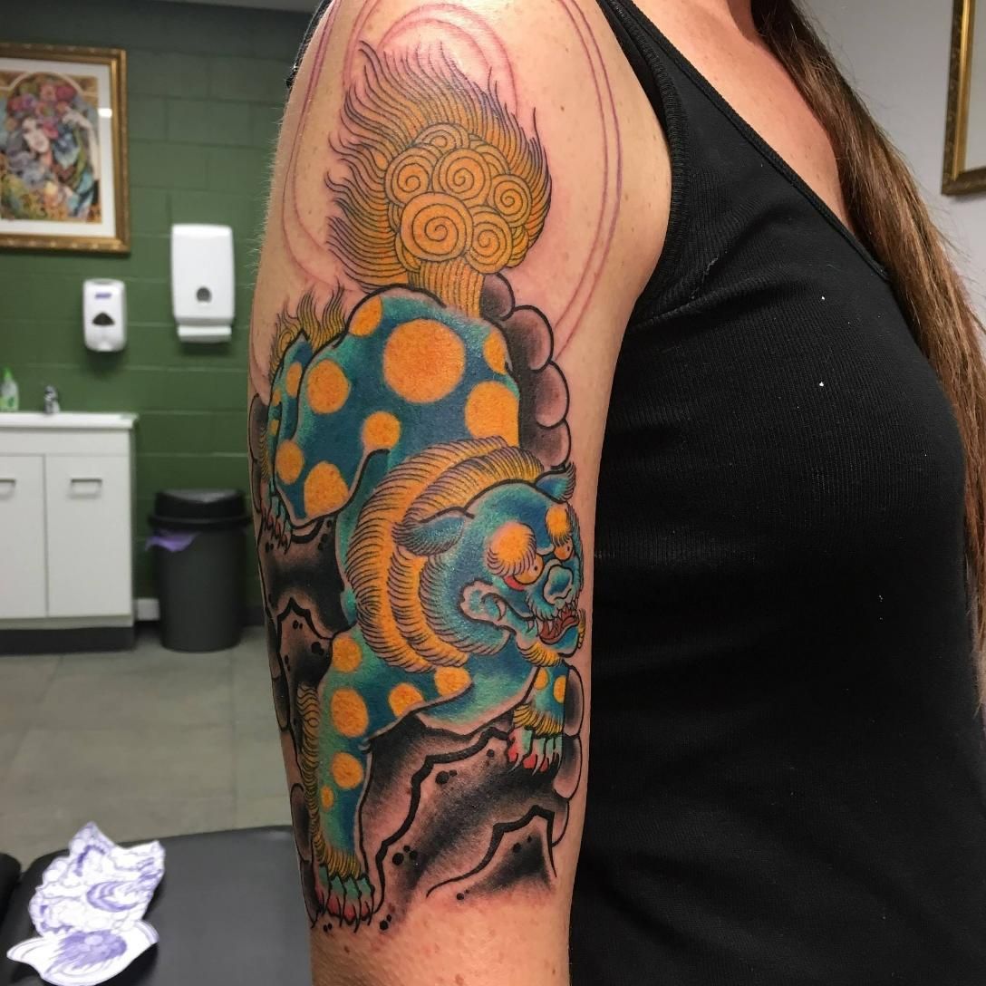 A Woman Has a Tattoo of a Lion on Her Arm — Gallery Tattoo in Nelson Bay, NSW