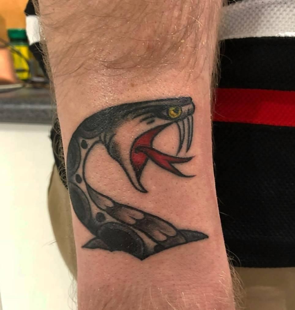 A Man Has a Tattoo of a Snake on His Wrist — Gallery Tattoo in Nelson Bay, NSW