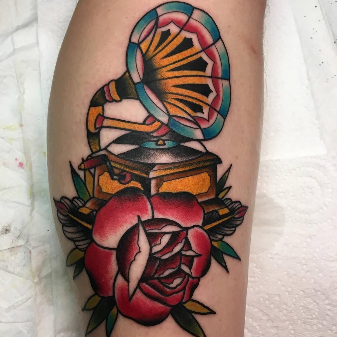 A Tattoo of a Gramophone and a Rose on a Leg — Gallery Tattoo in Nelson Bay, NSW