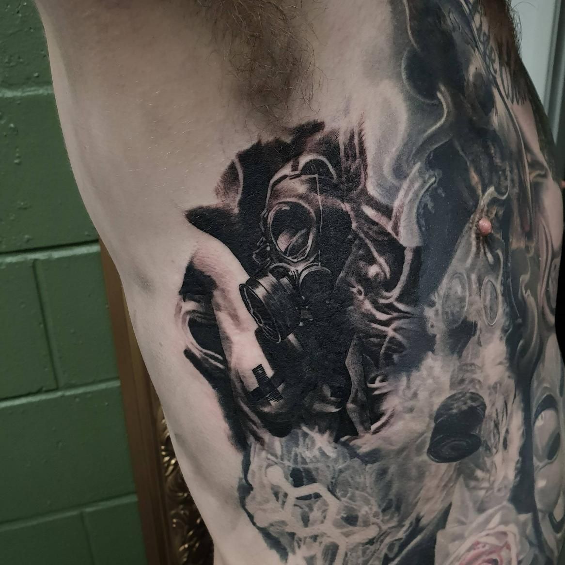 A Man Has a Tattoo of a Gas Mask on His Side — Gallery Tattoo in Medowie, NSW