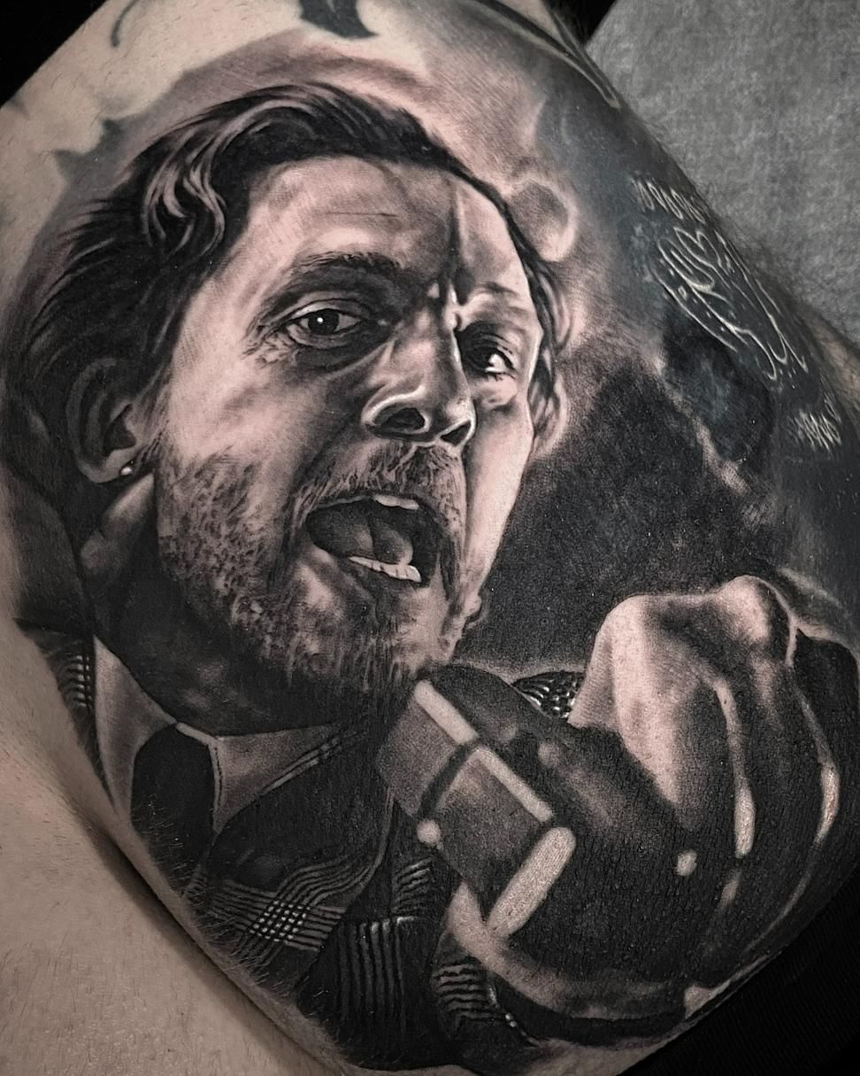 A Black and White Tattoo of a Man in a Suit and Tie Holding a Microphone — Gallery Tattoo in Medowie, NSW