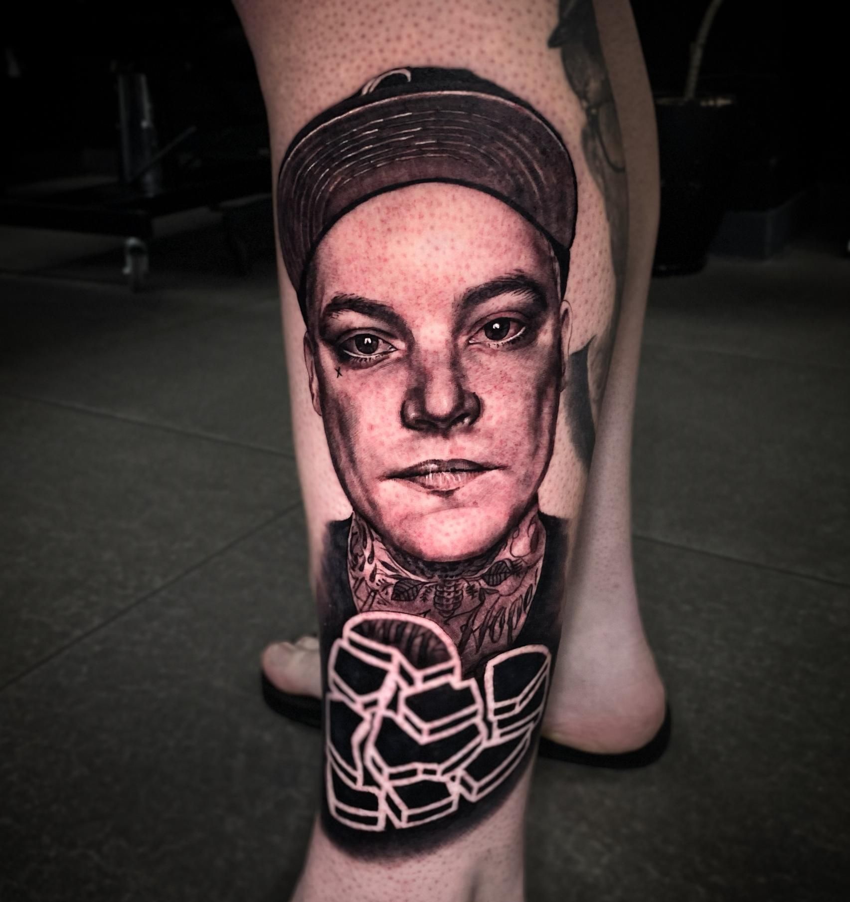 A Person Has a Tattoo of a Man 's Face on Their Leg — Gallery Tattoo in Medowie, NSW