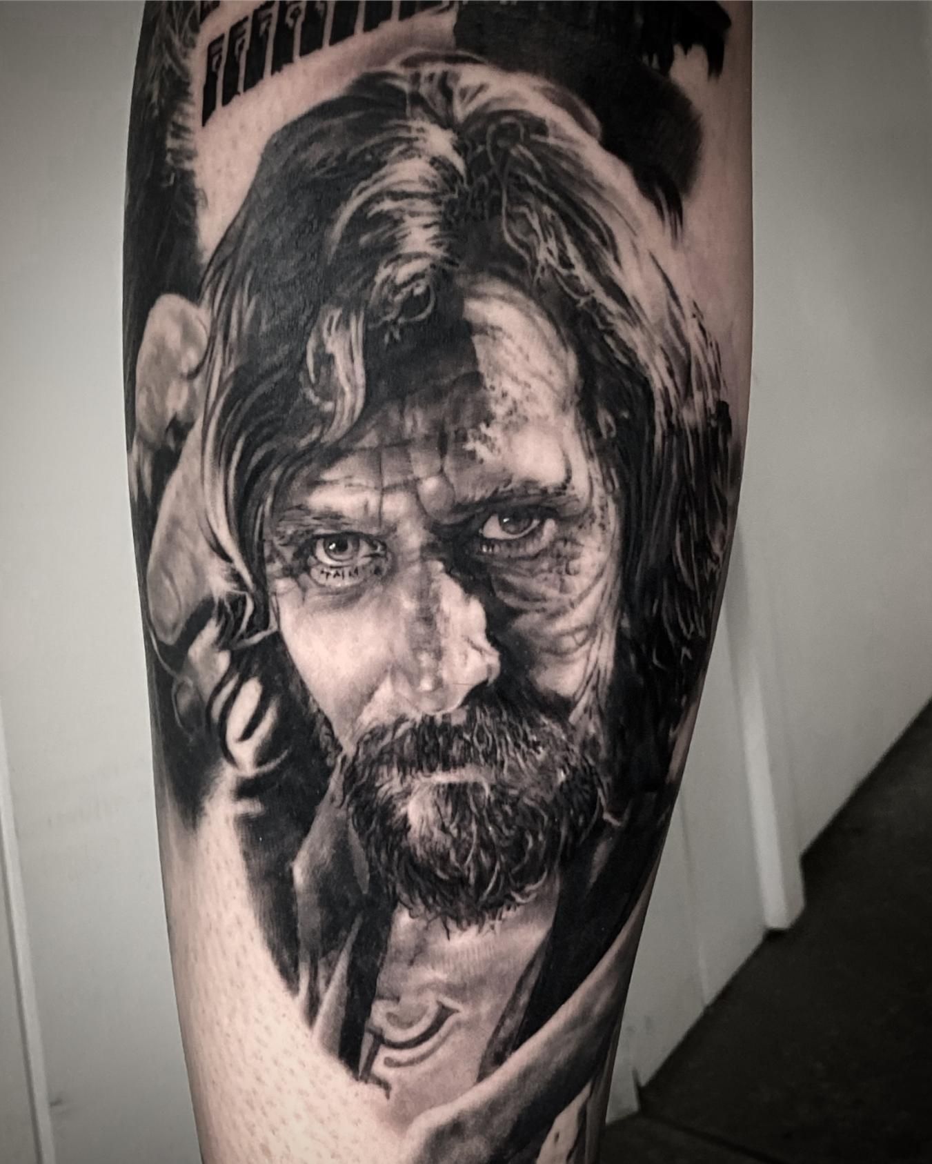 A Black and White Tattoo of a Man With a Beard on His Leg — Gallery Tattoo in Medowie, NSW