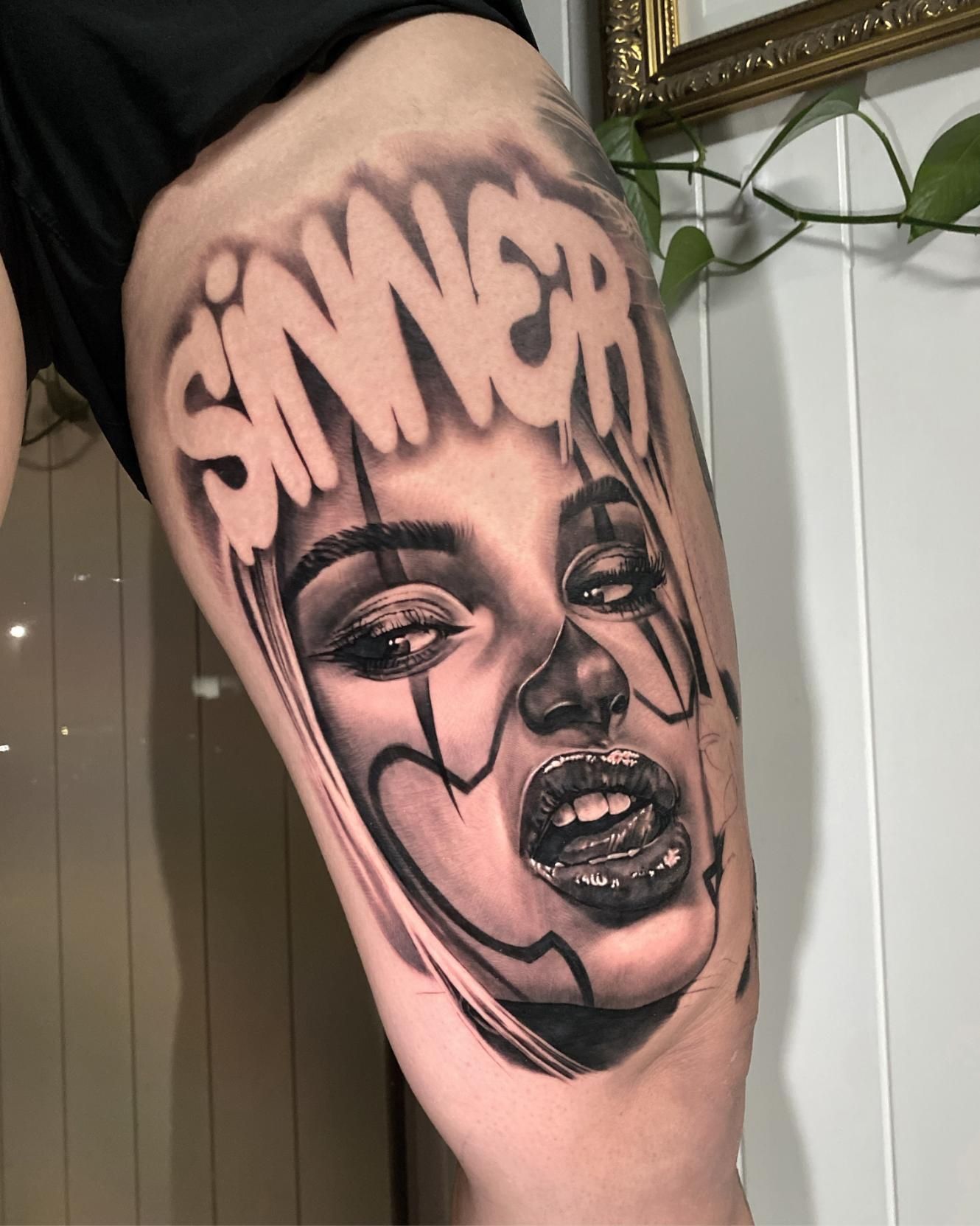 A Tattoo of a Woman 's Face With the Word Sinner on It  — Gallery Tattoo in Medowie, NSW