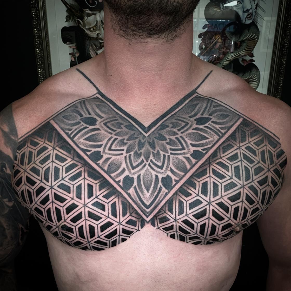 A Man Has a Black and White Tattoo on His Chest — Gallery Tattoo in Medowie, NSW