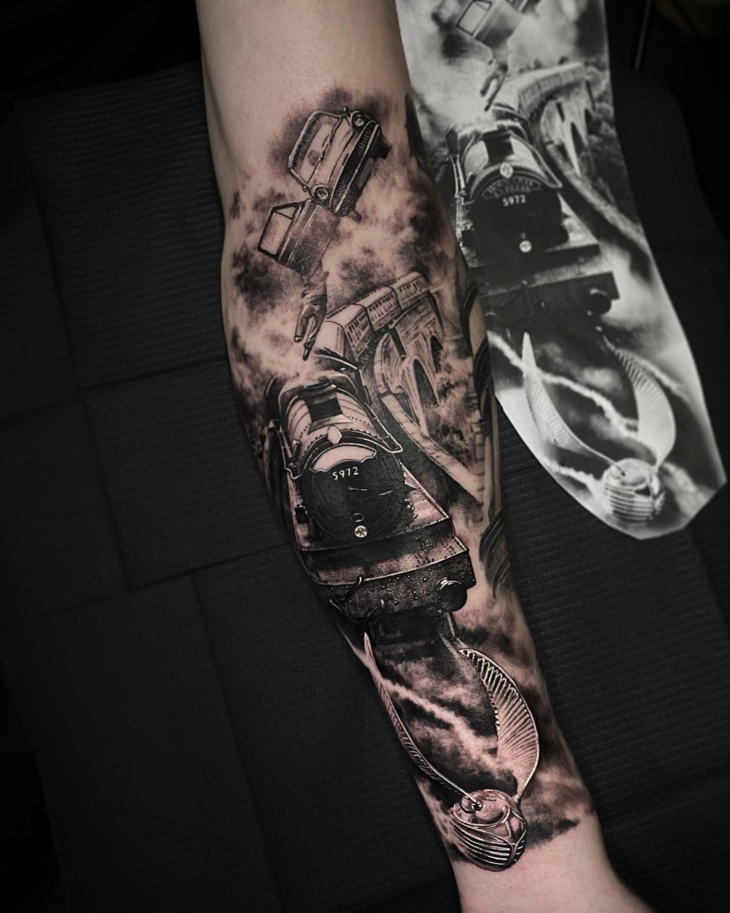 A Black and White Tattoo of a Train on a Person 's Forearm — Gallery Tattoo in Medowie, NSW