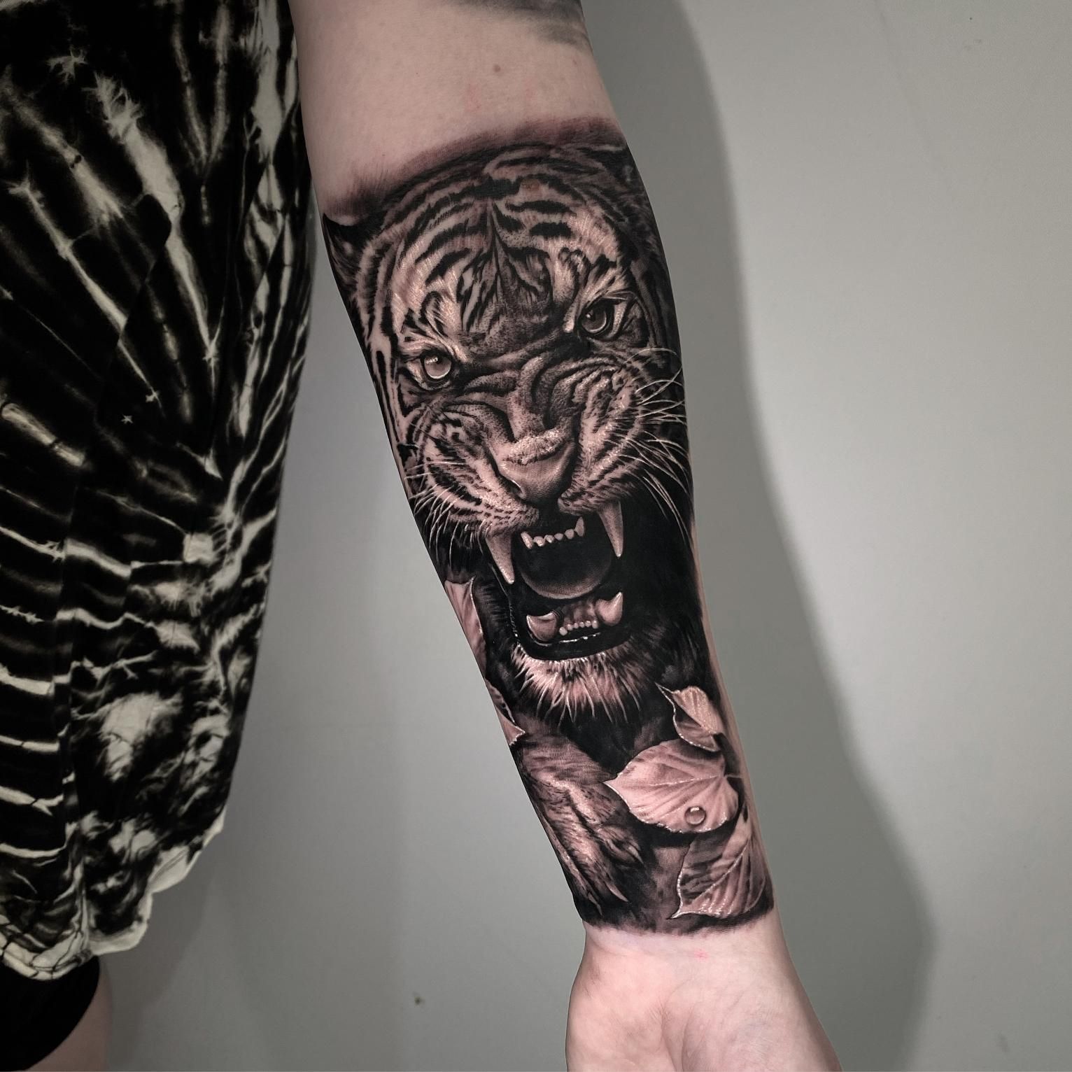 A Person Has a Tattoo of a Tiger on Their Forearm — Gallery Tattoo in Medowie, NSW