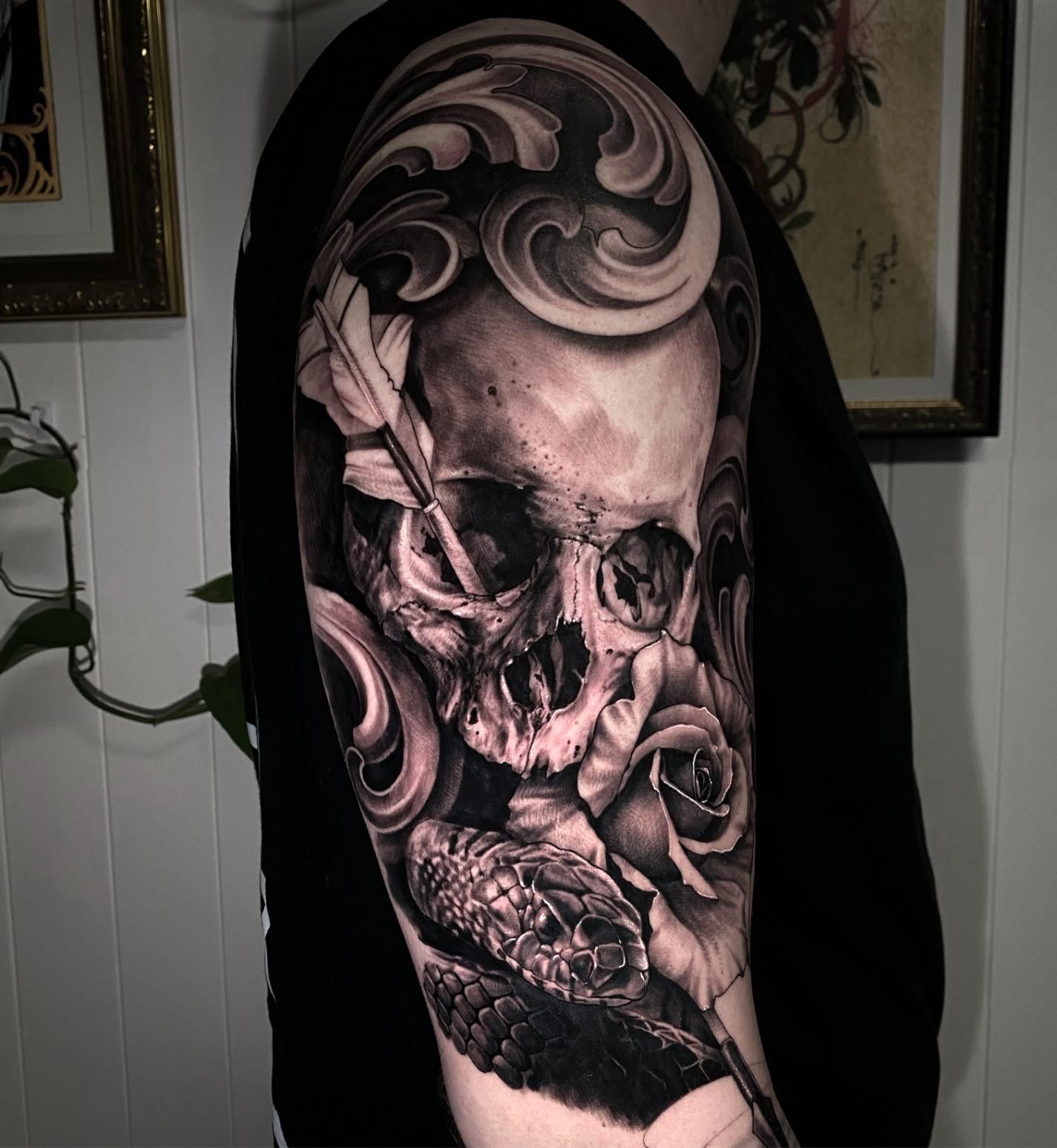 A Man Has a Tattoo of a Skull and Roses on His Arm — Gallery Tattoo in Medowie, NSW