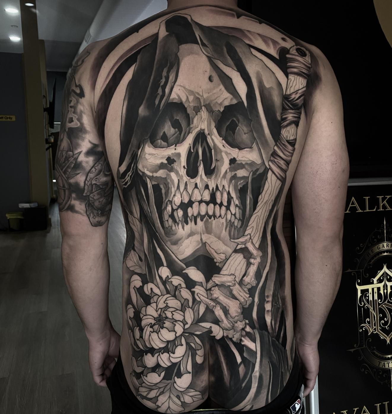 A Man Has a Large Skull Tattoo on His Back — Gallery Tattoo in Medowie, NSW