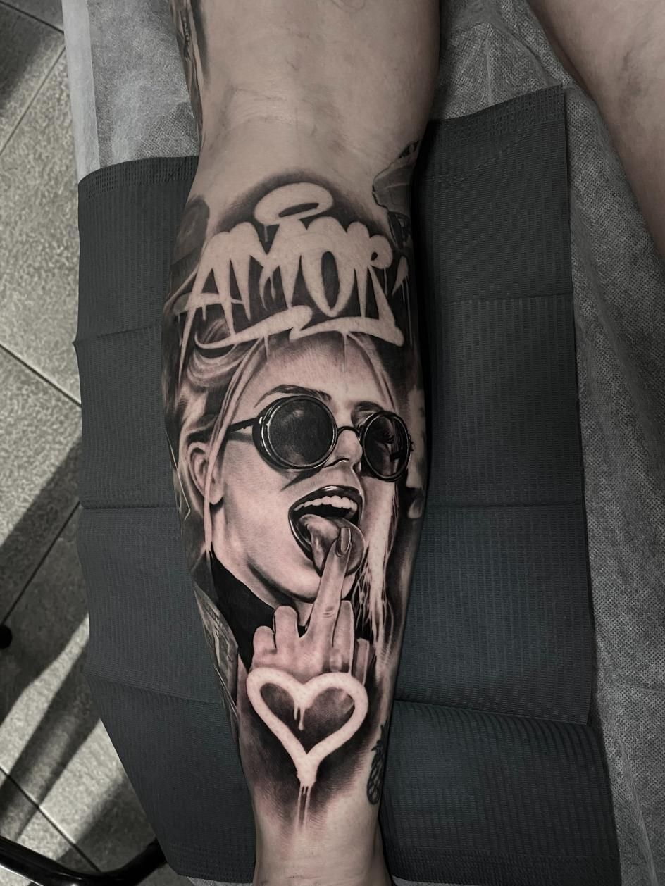A Black and White Tattoo of a Woman With Sunglasses on Her Arm — Gallery Tattoo in Medowie, NSW