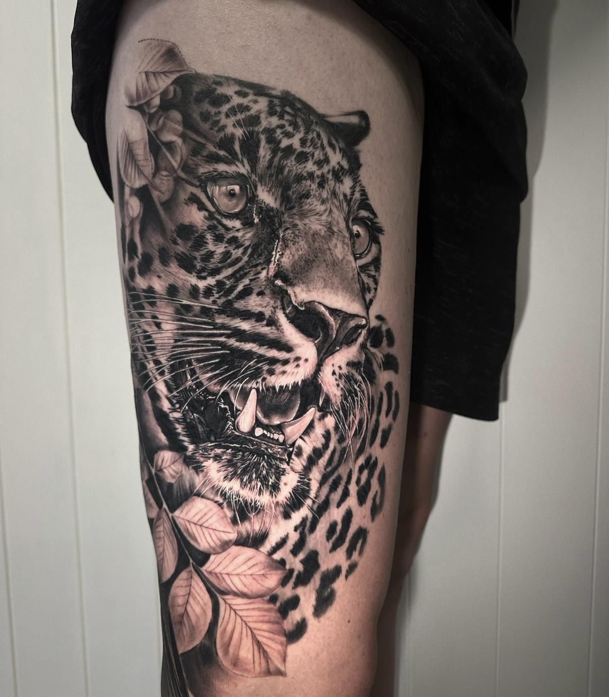 A Black and White Tattoo of a Leopard on a Person 's Leg — Gallery Tattoo in Medowie, NSW