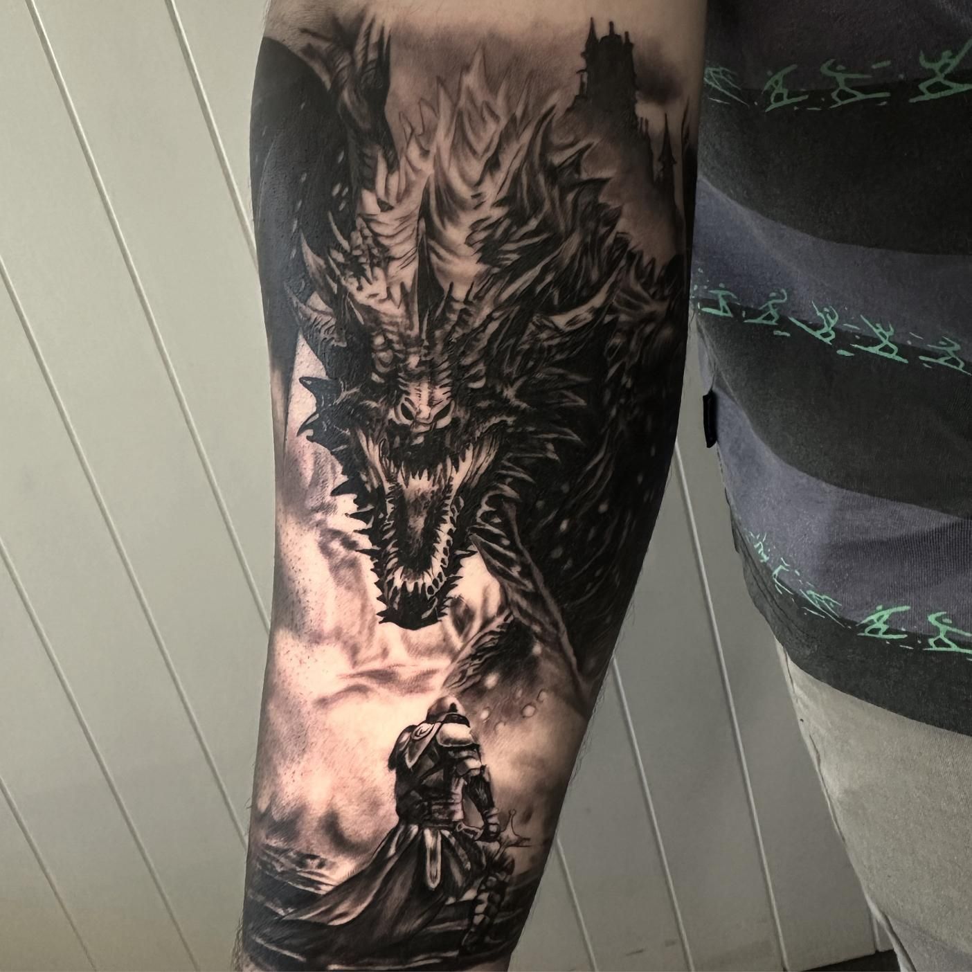 A Man Has a Tattoo of a Dragon and a Knight on His Forearm — Gallery Tattoo in Medowie, NSW