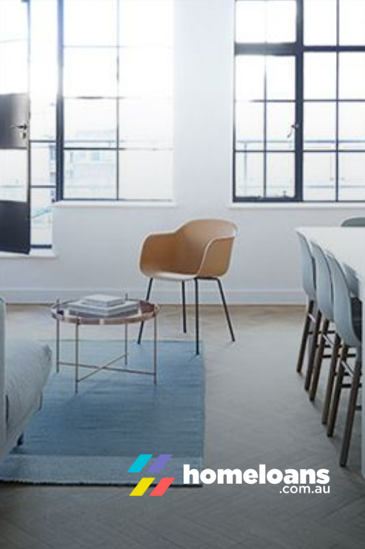 Bright interior with modern furniture: chair, table, rug, dining table, and large windows. homeloans.com.au logo.