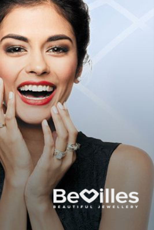 Woman smiling, showing rings; 