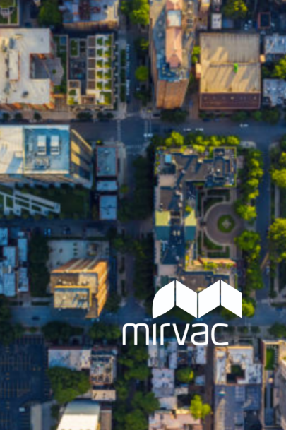 Overhead view of a city with the Mirvac logo overlaid. Buildings and streets are visible; logo is white.
