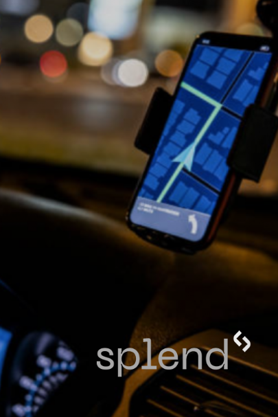 Smartphone with map app in car mount, night setting.